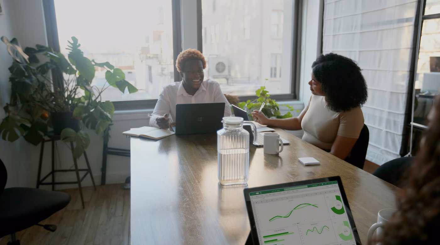 Team reviewing work around laptops as an example of human oversight in AI systems